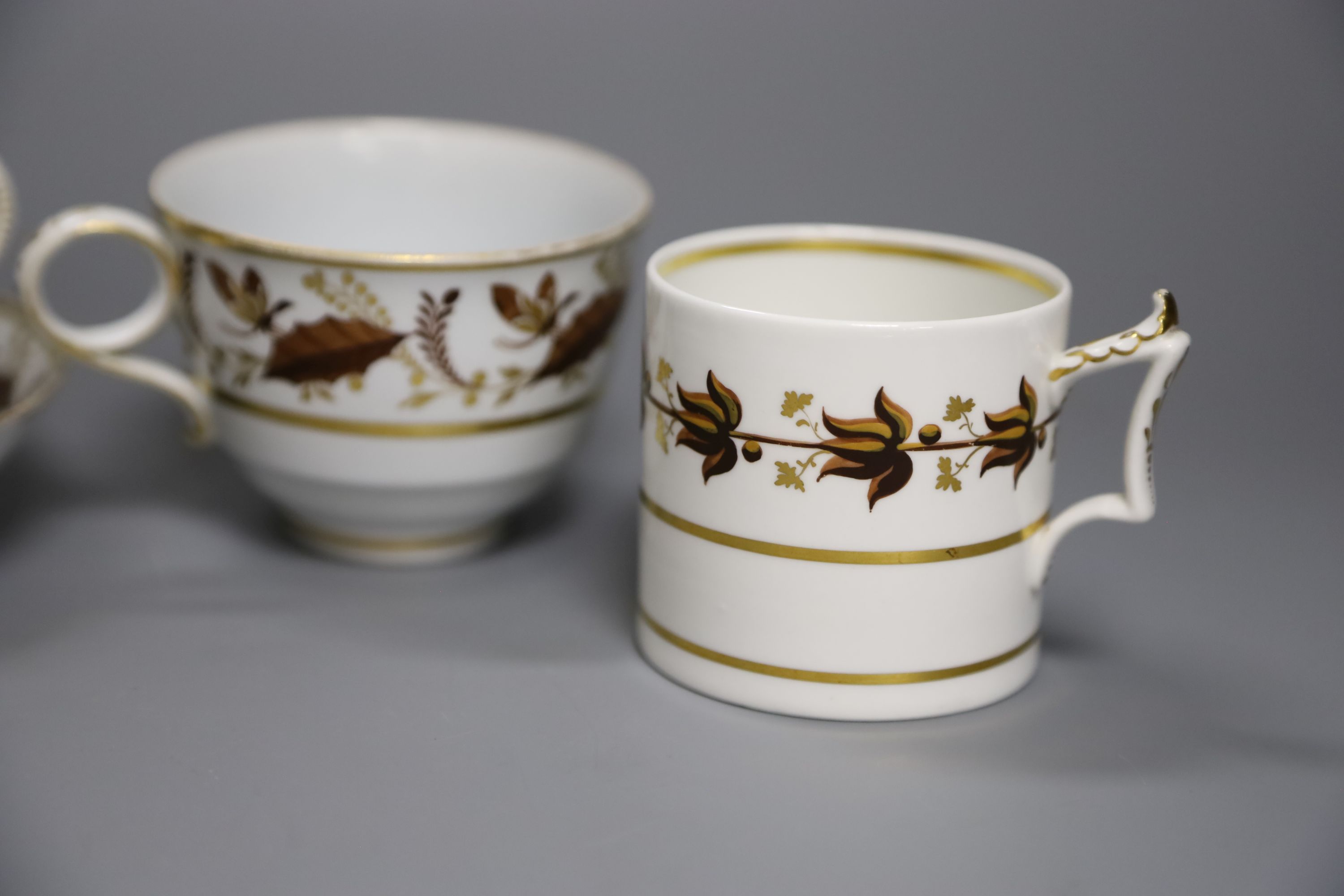 An early 19th century Worcester teacup and saucer painted with brown leaves with a landing insect, incised B, a Worcester coffee can